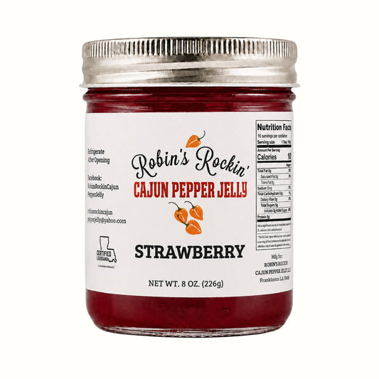 New Soul Robin's Rockin strawberry habanero pepper jelly in a glass jar with a metal lid on a neutral background.